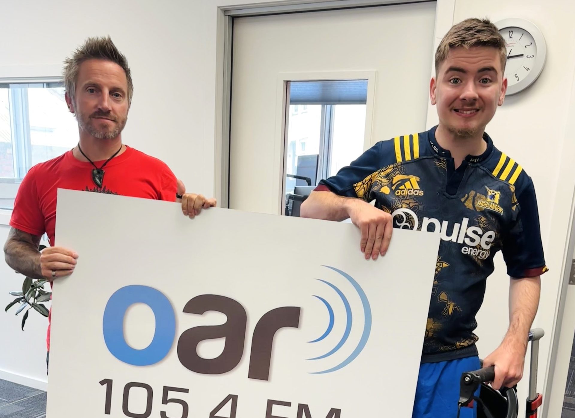 Nathan and Eddie in front of OAR FM sign