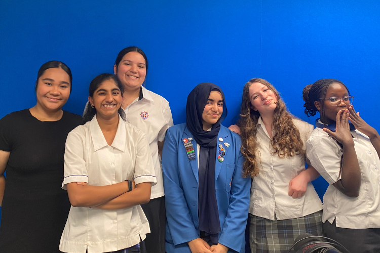 Members of the Dunedin Youth Council against a blue wall at OAR FM