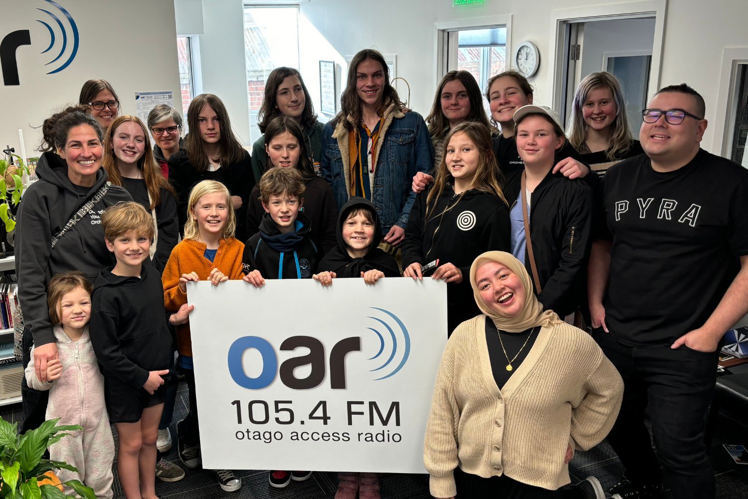 Group photo of Homeschool Students and parents in front of OAR FM Sign