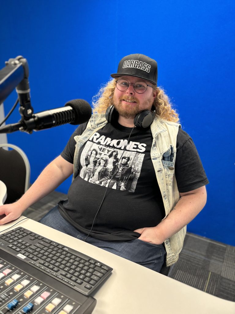 Photo of Host Tyler West in Pre-Recording Studio