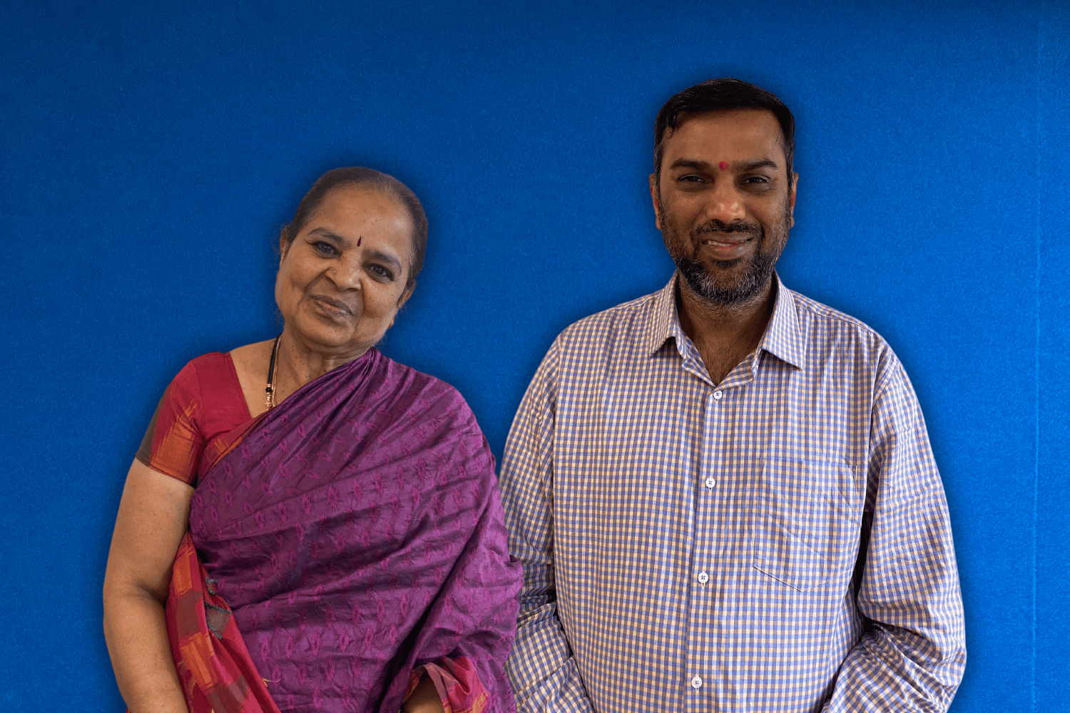 A photo of Nirmala Velamoor and Kesava Kovanur Sampath from Bhakti Margam NZ Charitable Trust against OAR FM Blue Wall