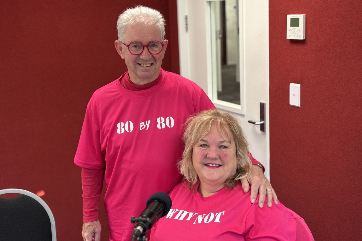 Artist Ron Esplin and That Blind Woman Julie Woods in OAR FM Studios, wearing bright pink t-shirts.