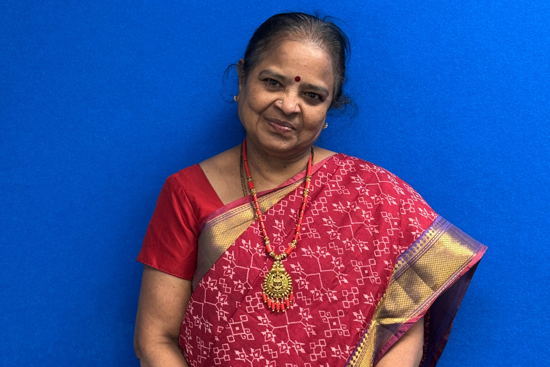 Nirmala Velamoor Host of Vasudhaiva Kutumbakam wearing a gorgeous red saree