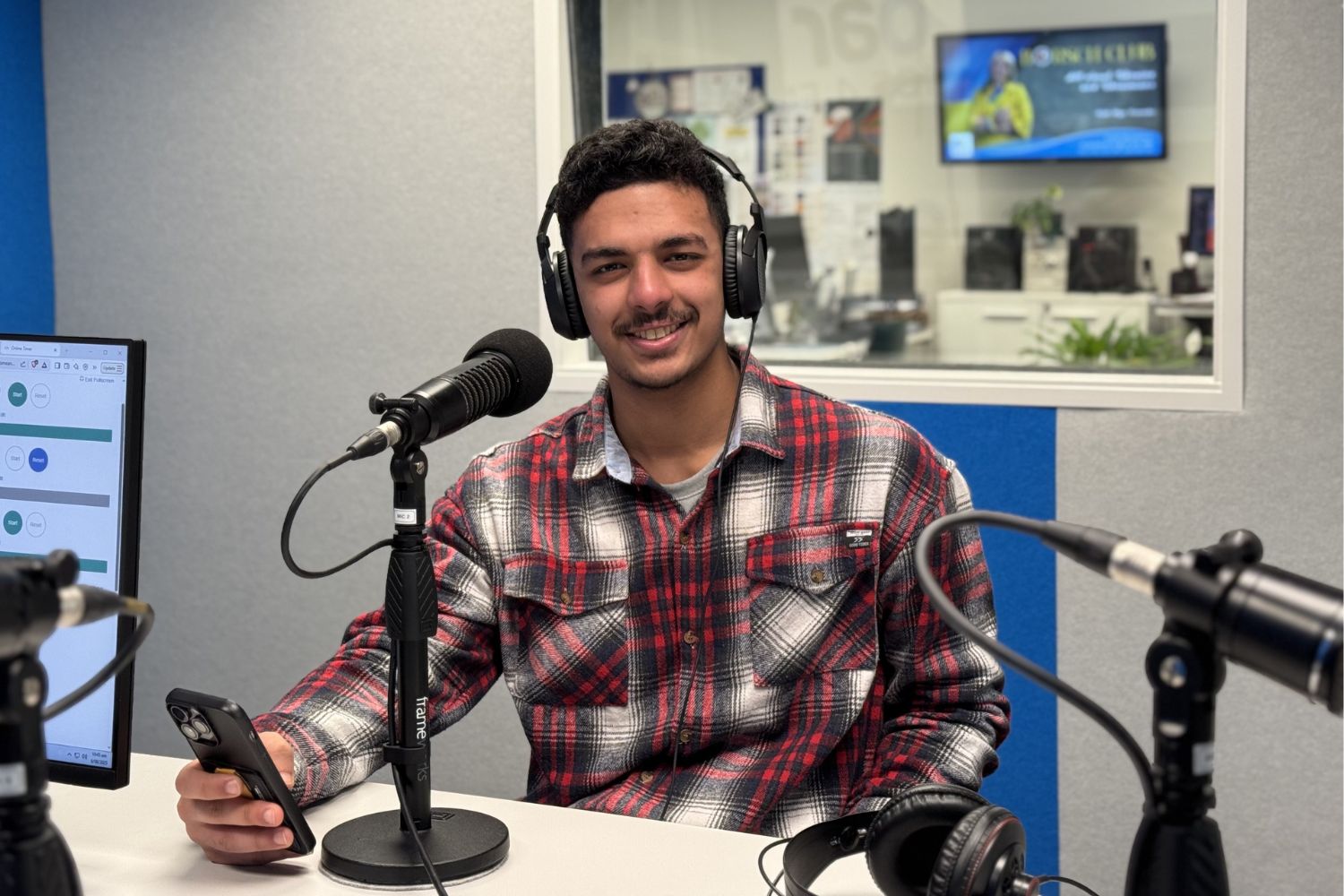 Burhan Alsaad in recording studio in front of a microphone