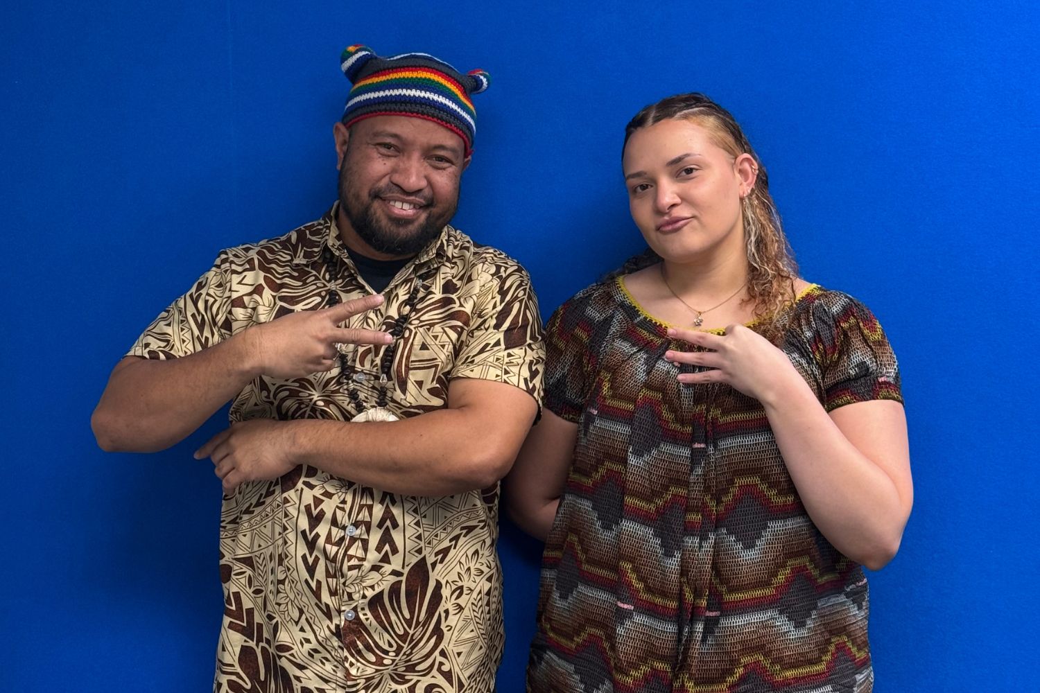 Papua New Guinea community members Nigani Willie and Ohela Hoffmeister at OAR FM walls.