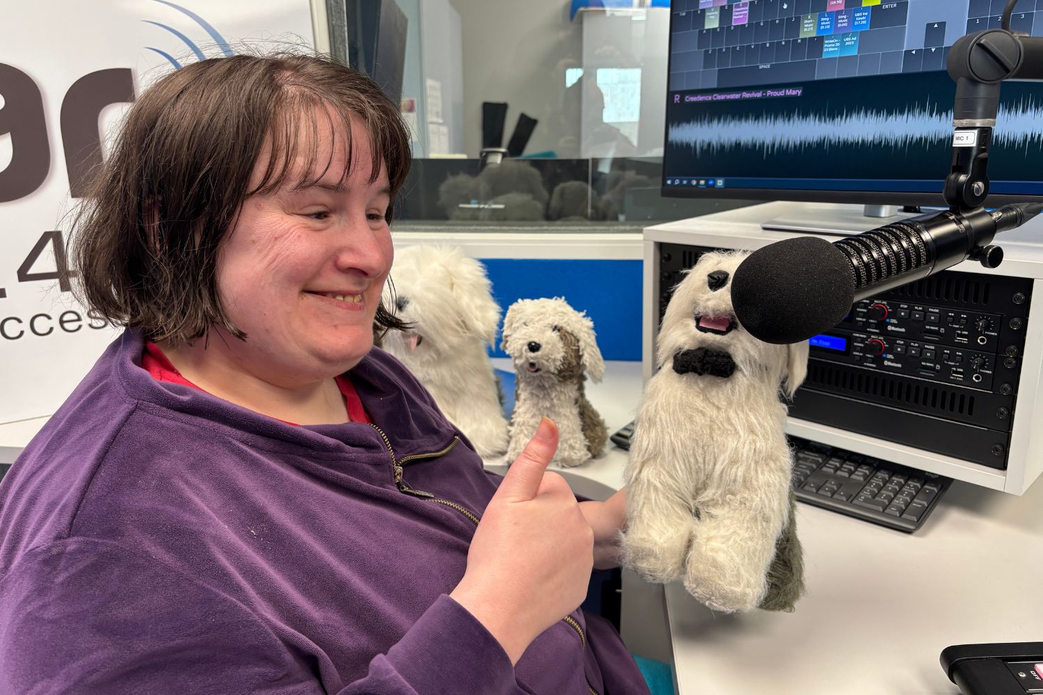Julia Young from The Positivity Show with her animal friends infront of the microphone.