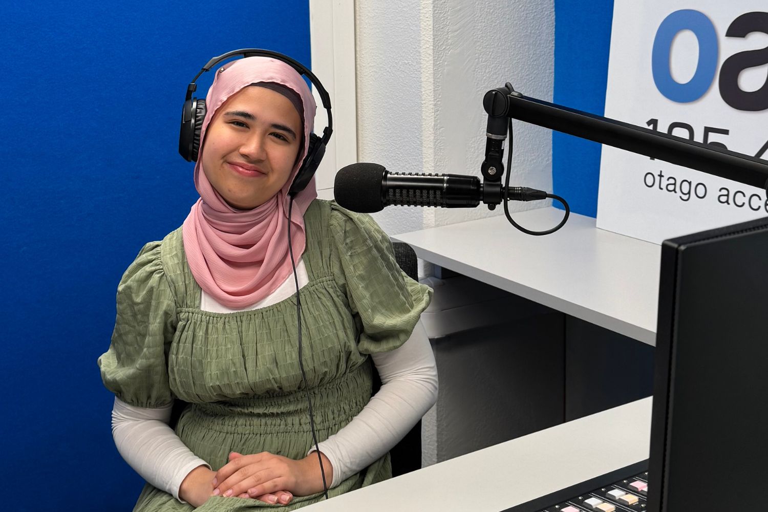 A photo of Edelweiss Fatima von Hofler from Girl Annotated infront of the OAR FM studio microphones.